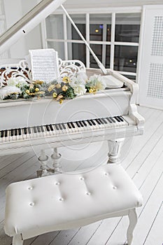 White piano in a white interior. Luxury interior.