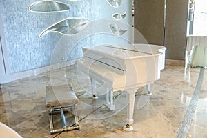 White piano in a white interior and luxury room.
