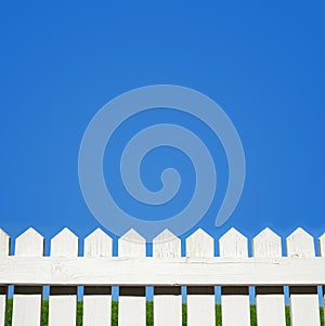 White picket fence and blue sky