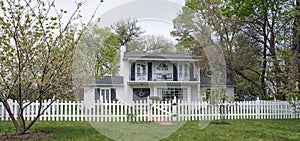White Picket Fence in Front of Two-story House