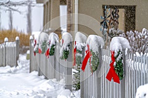 White picket fence with wreaths in Daybreak Utah