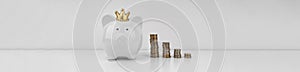 White piggi bank and stacks of coins on white background