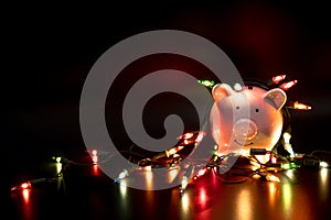 White piggy bank with Christmas string lights on happy December festival, Enjoy savings for spending money on the holiday`s