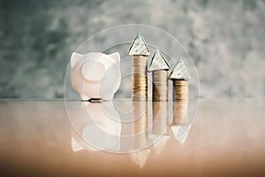 White piggy bank and coin on wood