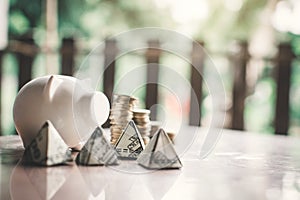 White piggy bank and coin on wood