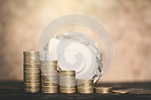 White piggy bank and coin on wood