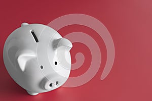 White piggy bank Placed on the red background.