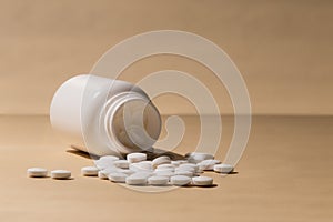 White Pill Bottle with Scattered Pills