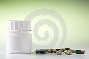 White pill bottle and various pills photo