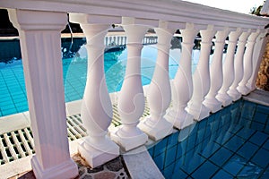 White pillars classic balustrade with empty pool.