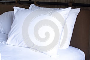a white pillow on the bed. Bed linen in the hotel