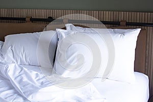 a white pillow on the bed. Bed linen in the hotel