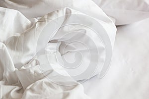 white pillow on bed and with wrinkle messy blanket in bedroom, f