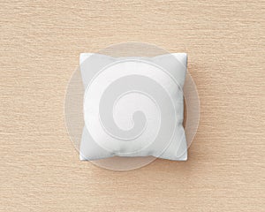 White pillow and square shape on wood floor background with blank template. Pillow mockup for design. 3D rendering