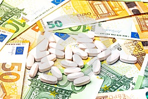 White pills on the background of euro bills