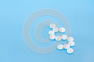 White pills on a blue background