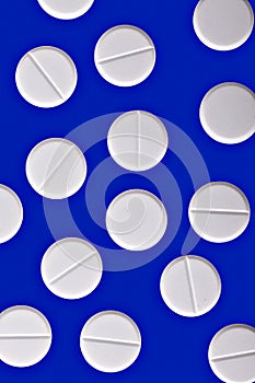 White pills on blue medicine cure background photo