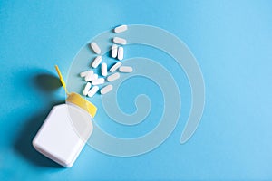 White pills, capsules in plastic bottle