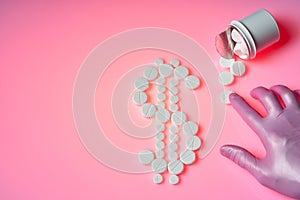 White pills are in the form of a dollar sign on a pink background, a bottle with medicines, a hand in a glove moves the pill.