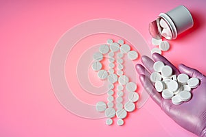 White pills are in the form of a dollar sign on a pink background, a bottle with medicines, many white pills are in the palm of