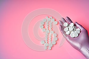 White pills are in the form of a dollar sign on a pink background, many white pills are in the palm of your hand. Healthcare is a