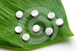 White pills on leaf