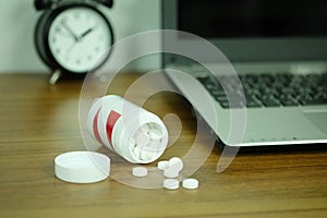 White pills and medicine bottles, paracetamol on the desk wooden table, Headache medicine Vitamin And Dietary Supplements