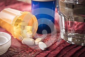 White Pills spilling from an open ambar bottle, conceptual image photo