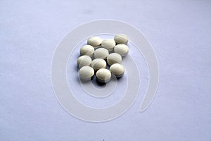 White pills on white with blur effect