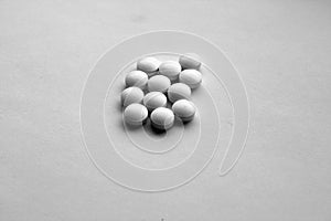White pills on white with blur effect in black and white