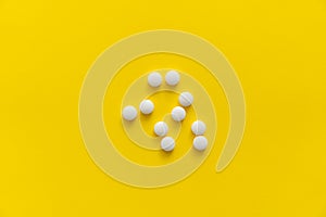 White pills on yellow background. Medicine, medication, painkillers, tablet, medicaments, drugs, antibiotic, vitamin