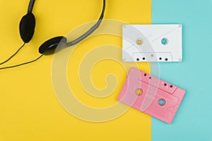 The white and pink audio cassette tapes with a black headphone