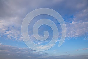 White and pink Cirrus clouds on a blue sky on a summer evening, background