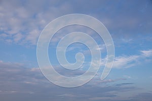 White and pink Cirrus clouds on a blue sky on a summer evening, background