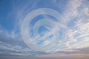 White and pink Cirrus clouds on a blue sky on a summer evening, background