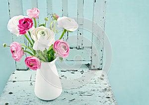 White and pink flowers on light blue chair