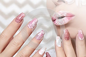 White pink pastel manicure and lip makeup .