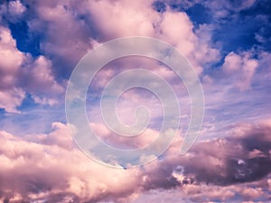 White and pink puffy clouds in blue sky