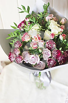 The white and pink spray roses in a gray floral paper