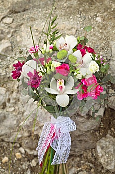 White and pink wedding bouquet on a rock background