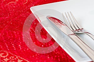 White place setting on red