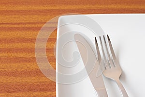 White place setting on wooden table