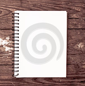 white plain notebook for social media marketing post with wooden background