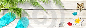 White planks panoramic background with seashells, flip flops and plam tree Tropical beach summer web banner