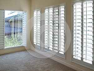 White plantation style wood Shutters photo