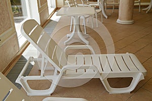 White plastic beach chair is inside the luxurious swimming pool