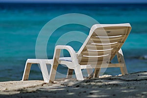 White plastic beach chair on Maafushi Island, Maldives.