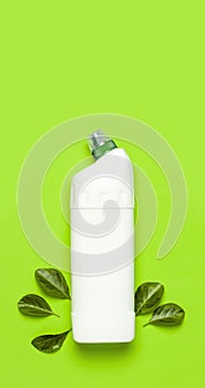 White plastic bottle for liquid detergent, cleaning agent, bleach, antibacterial gel with natural plant extract and green leaves