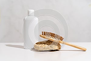 White plastic bottle mock up, used for shampoo and conditioner and hair wood comb on white background