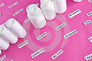 White plastic bottles with pills and coronavirus, pandemic headline clipping words on pink background